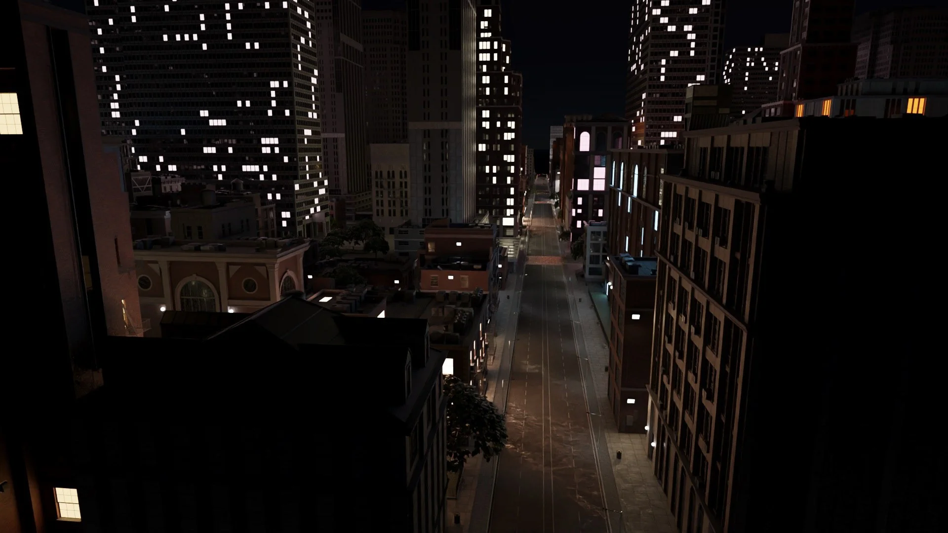 Nighttime cityscape looking down an illuminated street between tall buildings